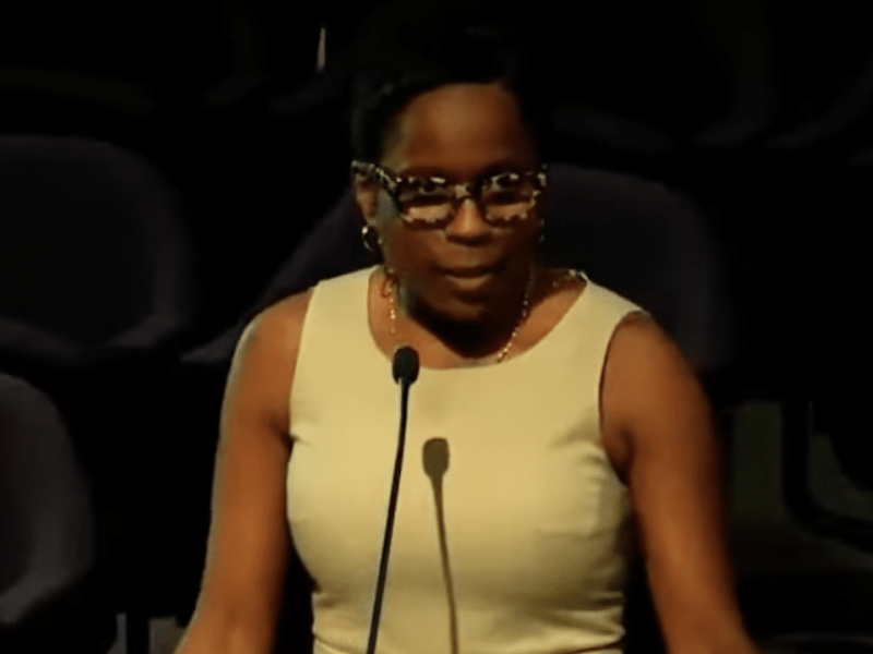 Inspector General Shannon Manigault standing at a podium inside Atlanta City Council Chambers