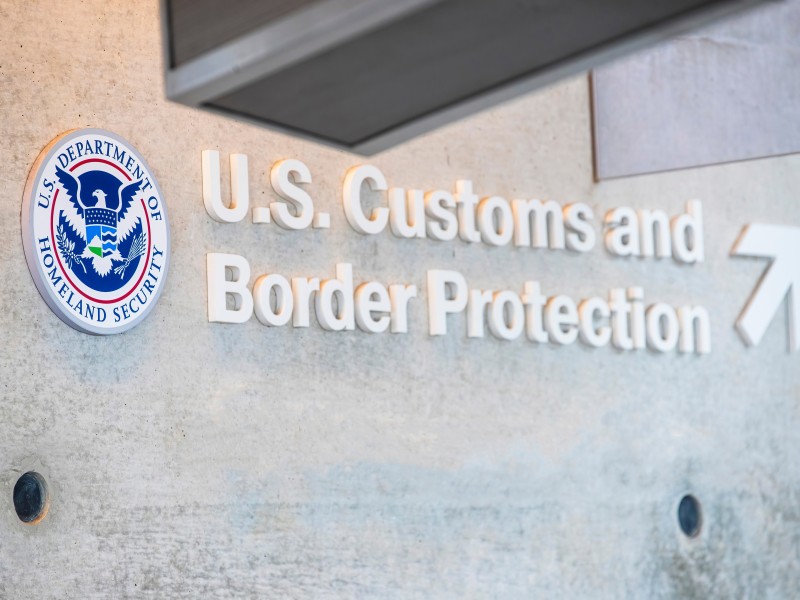 Los Angeles USA A sign for U.S. Customs and Border Protection with the Department of Homeland Security seal displayed on a concrete wall.