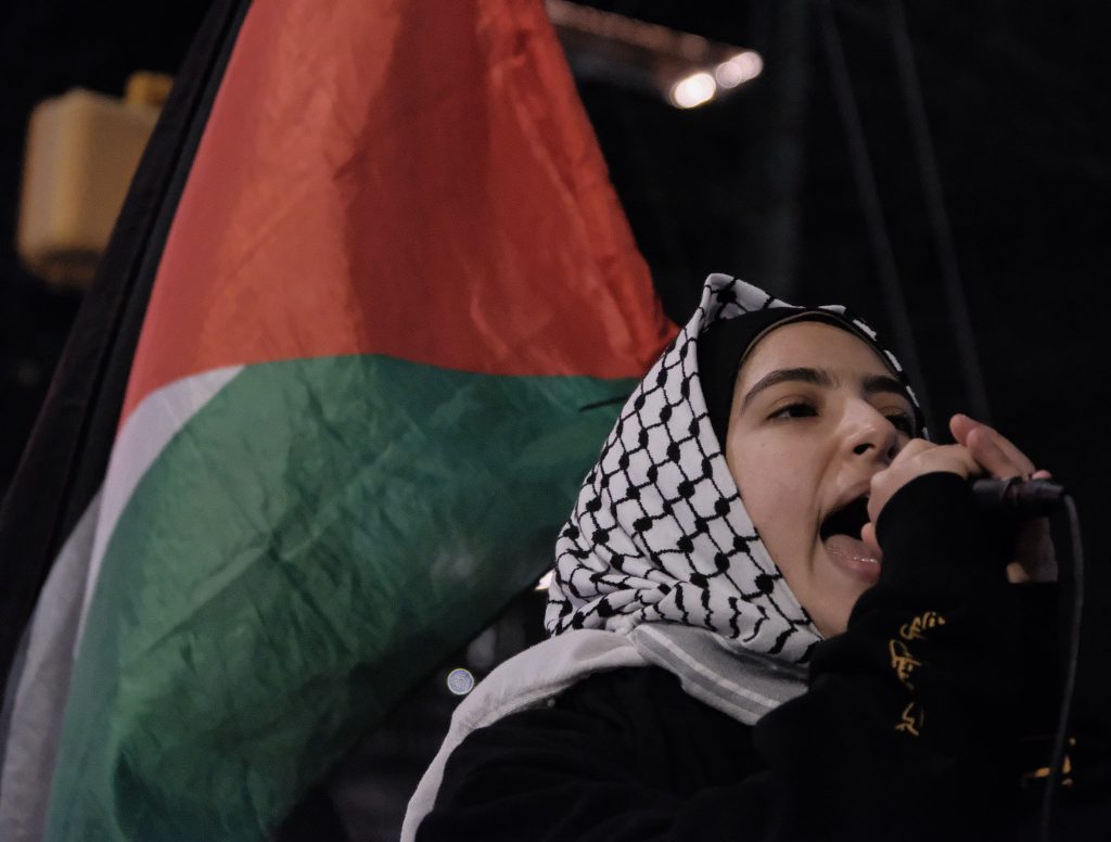Bisan Hammid, an organizer with Palestinian Youth Movement, addresses the crowd at Thursday's demonstration following the announcement of a ceasefire agreement between Israel and Hamas. (John Arthur Brown)