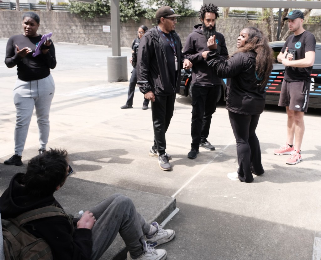 PAD Atlanta's Community Response team members on site during a live diversion, which often involves team members engaging with local law enforcement to divert the nature of a situation from a possible detention or arrest.