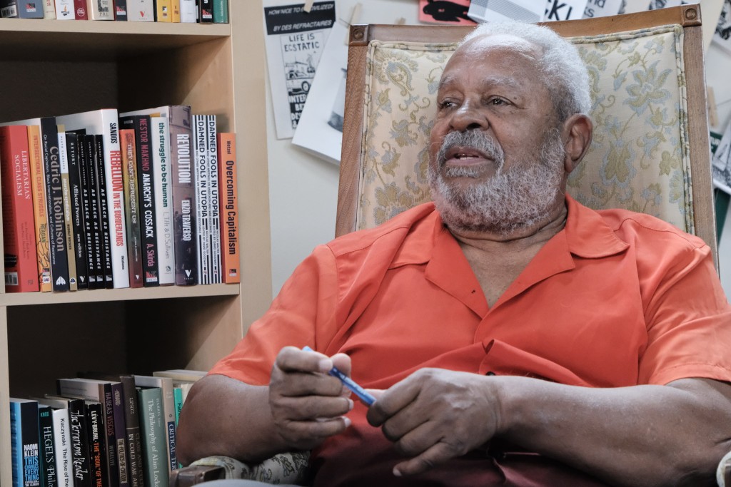 Sitting in a chair in a bookstore, Modibo Kadalie, an author, social ecologist, and lifelong organizer, speaks on the history of racism in Stone Mountain, Georgia.