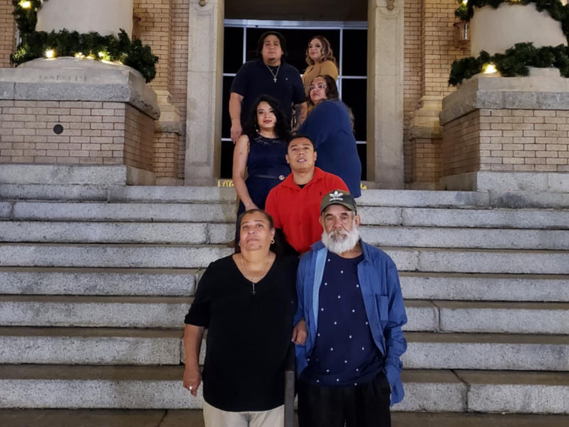 The family of Aberlardo Avellandeda-Delgado standing on the steps of a building. Avellandeda-Delgado, a south Georgia grandfather, died while in transit in the custody of ICE contractors.