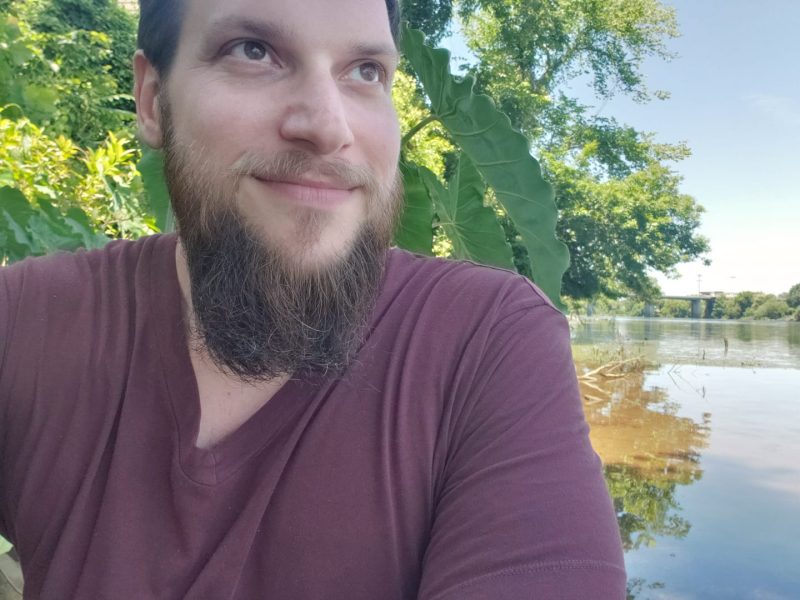 Matthew Cardinale sits beside the Savannah River.