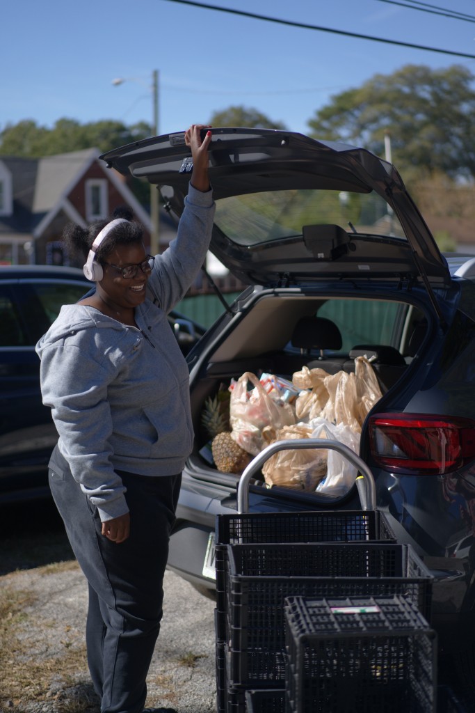 Chaiyoung loads her vehicle during her second stop in the afternoon on Saturday, Nov. 1, 2025, trying to make up for lost SNAP funds. (Jesse Pratt López)