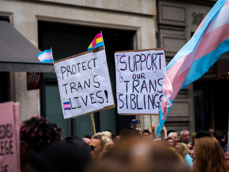 Trans health care support signs at a Pride parade in London.
