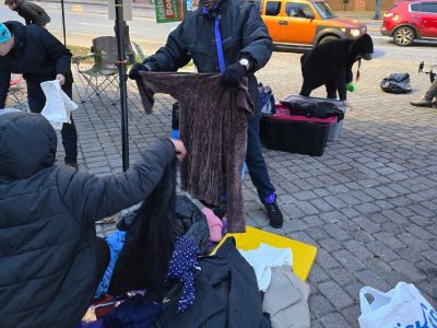 Allen Hall looks through donated clothing at “Sleep Out, Speak Out” event on Dec. 4. (Courtesy of Tim Franzen)