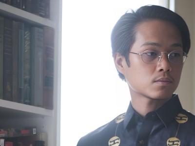 DACA recipient and photojournalist Ya'akub Vijandre, who was detained by ICE over social media posts, poses in front of library. (Courtesy of Yaa'kub Vijandre's family)