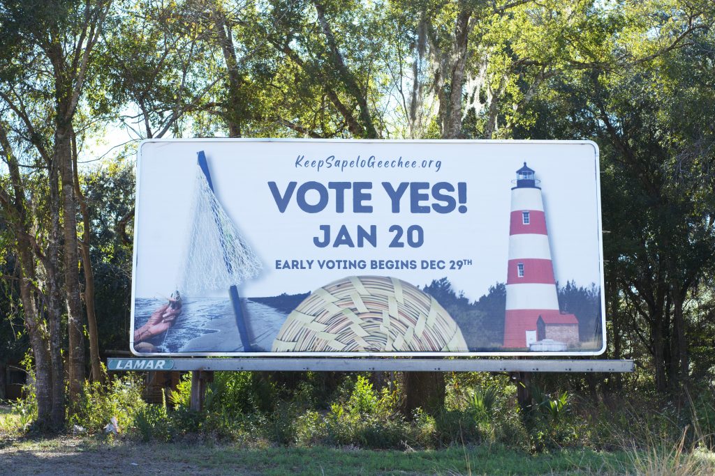 A billboard that says "VOTE YES! JAN 20" with a line below that reads "EARLY VOTING BEGINS DEC. 29TH." The billboard links to keepsapelogeechee.com