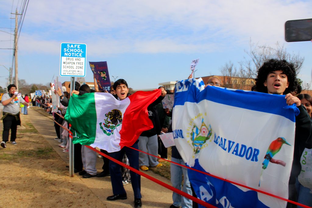 Students from Central Gwinnett High School stand on the sidewalk outside the school building on Jan. 30, 2026, as part of a nationwide student walkout over ICE actions in Minneapolis and other cities across the country. (Maya Omar)