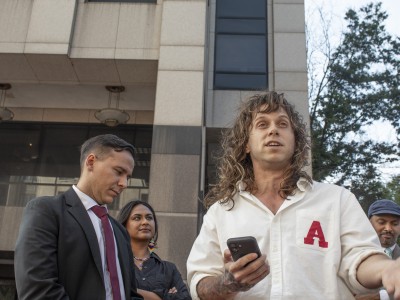 Jamie Marsicano speaks at a press conference, with her attorney Xavier T. de Janon standing behind her, outside the Fulton County Courthouse, following a motions hearing the 'Cop City' racketeering case on Sept. 8, 2025.