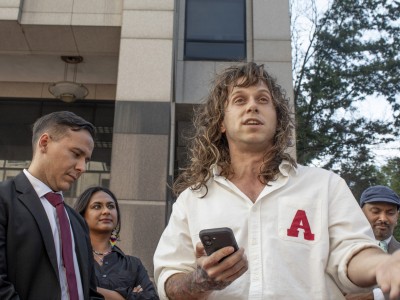 Jamie Marsicano speaks at a press conference, with her attorney Xavier T. de Janon standing behind her, outside the Fulton County Courthouse, following a motions hearing the 'Cop City' racketeering case on Sept. 8, 2025.