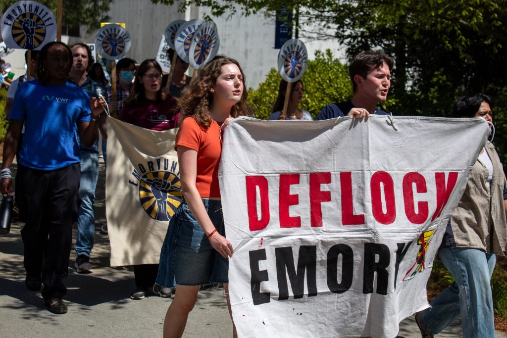 Emory University students, graduate teachers, faculty and staff walk through the campus quad to deliver a demand petition asking the university to remove Flock Safety cameras from all Emory campuses on April 10, 2026. Matt Scott/ACPC